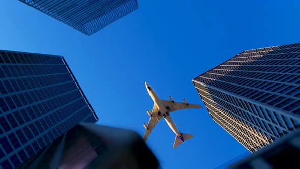 The Plane Flies Over The Buildings