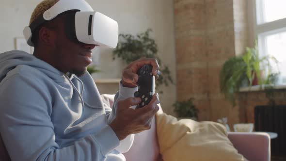 Black Man Enjoying Video Game on VR Headset at Home