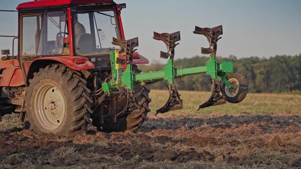 Farmer in tractor customize equipment for cultivating the soil