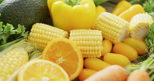 Video of fresh fruit and vegetables over wooden background