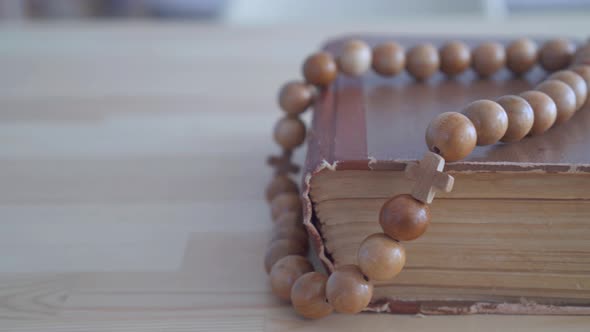 Close Up Rosary Lying on Bible