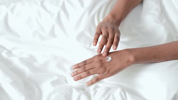 Hands Close Up Black African American Girl Applying Moisturizing Cream and Massage Arm for Softness