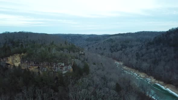 Aerial Shot of Cliffs Near Icy Mountain River