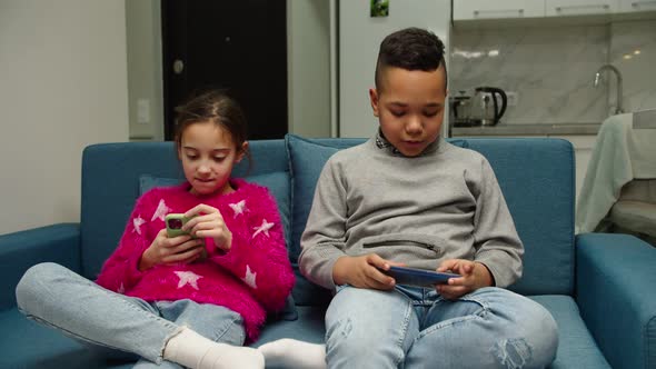 Kids Using Mobile App Playing Game Checking Social Media at Home