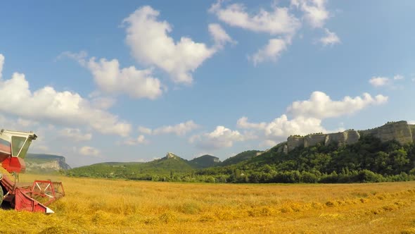 Combine Harvester Mowing Grains At Picturesque Place