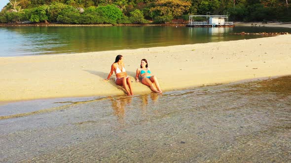 Girls happy together on tropical island beach wildlife by blue ocean and clean sand background of Th