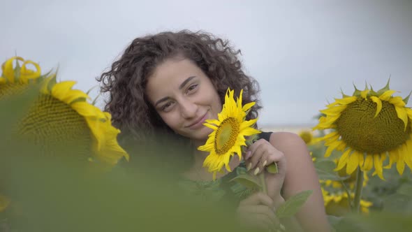 Portrait of Lovely Fun Curly Playful Sensual Woman Looking at the Camera Smiling Standing on