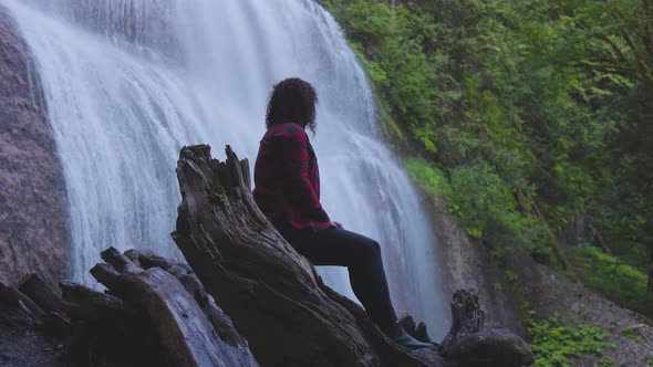 Woman Watching the Waterfall in the Canadian Rainforest