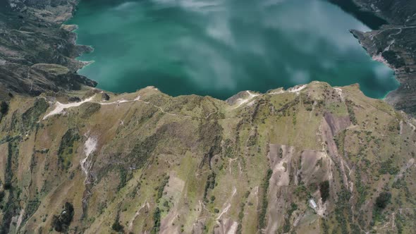 Fly Over Quilotoa Crater Lake In Ecuadorian Andes Volcano In South America. Aerial Tilt-up