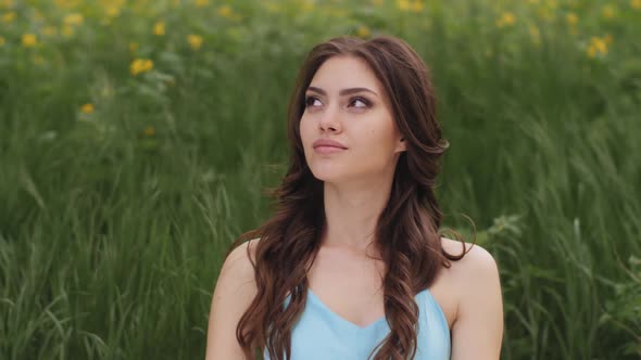 Spring Beauty Portrait of Woman on the Green Nature Background