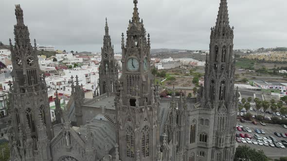 Orbiting shot around Arucas Church majestic towers in Gran Canaria, Canary Islands, Spain. Aerial vi