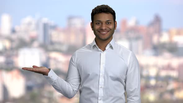 Handsome Businessman Presenting Something in His Palm