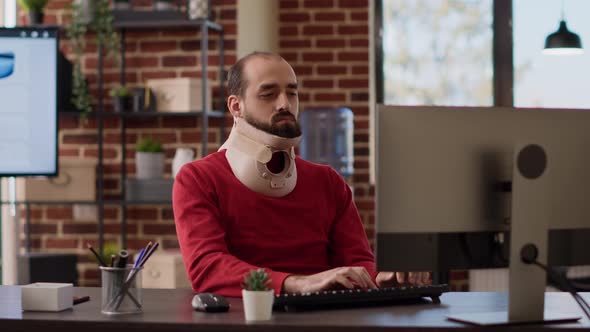 Business Man Using Neck Collar to Recover From Physical Injury