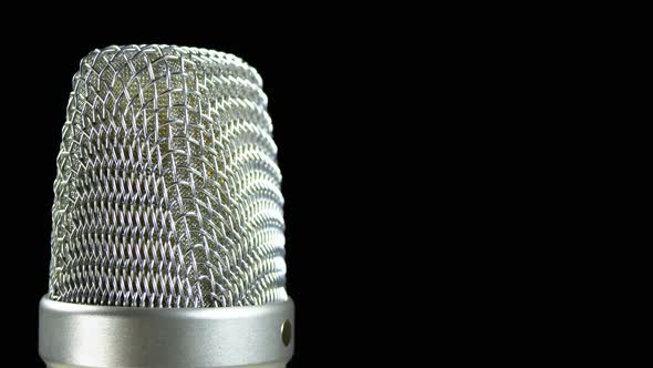 Studio Condenser Microphone Rotates on a Black Background