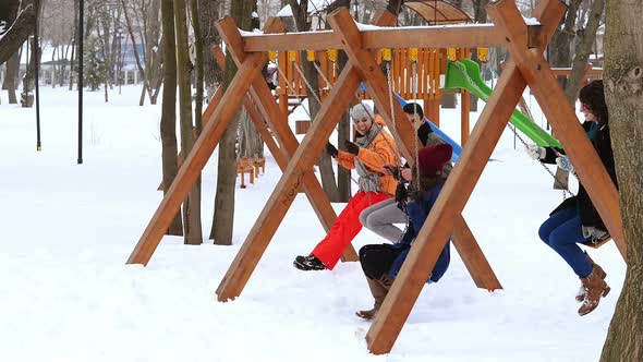 Friends Swinging in Park