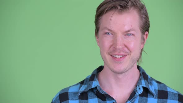 Face of Happy Young Handsome Hipster Man Thinking