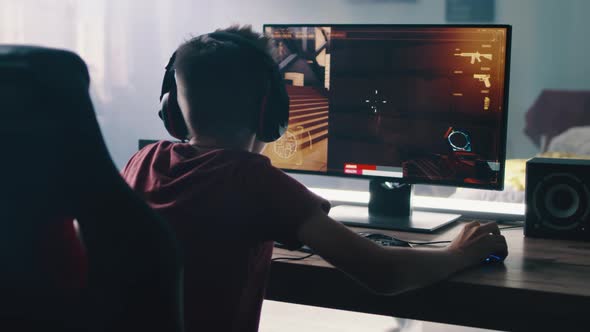 Teen Gamer Playing Shooter in Bedroom