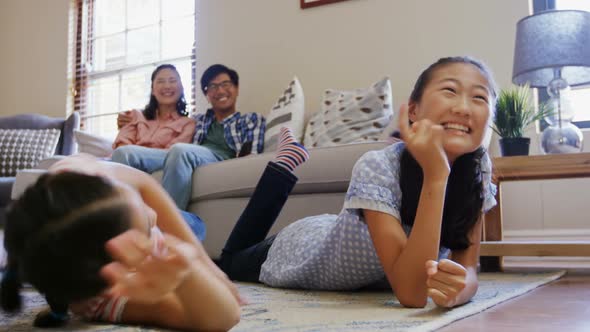 Happy family watching television together in living room 4k