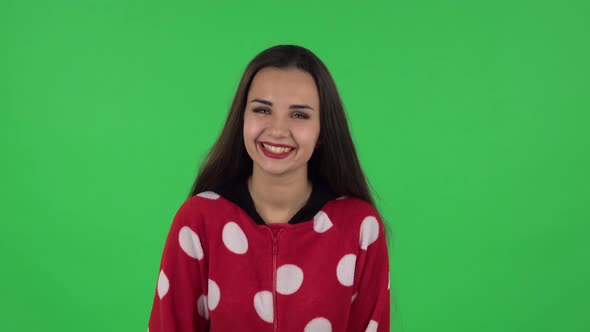 Portrait of Beautiful Girl in Red Fleece Pajamas Is Laughing. Green Screen