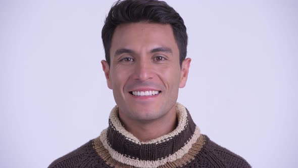 Face of Young Happy Hispanic Man Smiling Ready for Winter