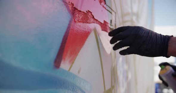 Graffiti artist touching the painted wall 4k