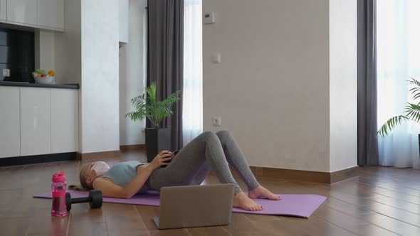 Woman Mask Using Dumbbell During Domestic Workout