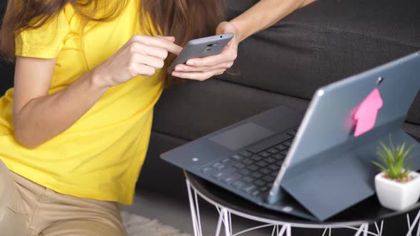 Young Businesswoman Browsing Internet on Smartphone at Work Place