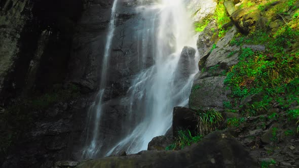 Mahuntseti Waterfall in Georgia, in a dense forest. theme of travel and nature,