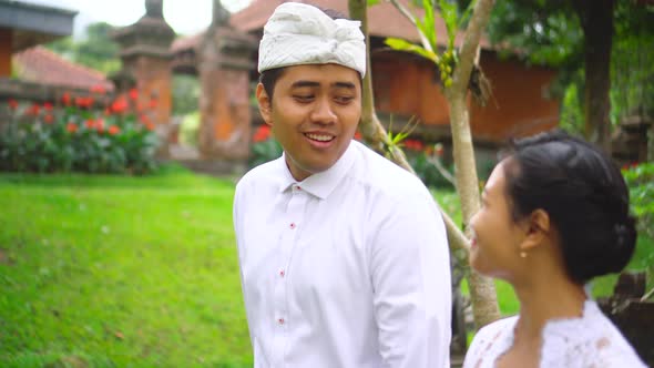 Romantic asian couple in traditional clothes walk and smile, happy family. Indonesian hindu people