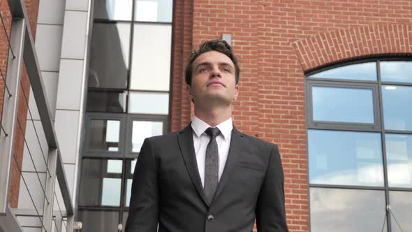 Pensive Young Businessman Walking for Meeting