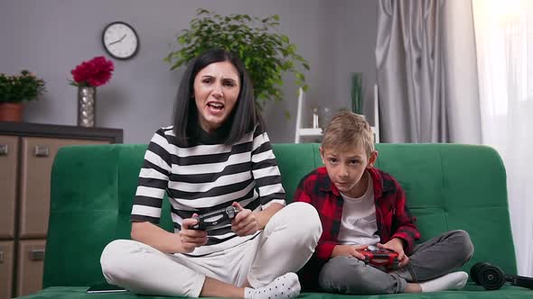 Mom and Her Funny 8-Aged Son Winning Together in Video Game and Giving High Five