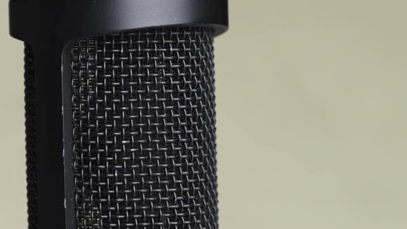 Studio Condenser Microphone Rotates on Yellow Background with Place for Text