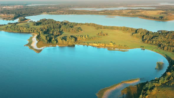 Aerial View Of Lake And Green Forest Landscape In Sunny Summer Morning