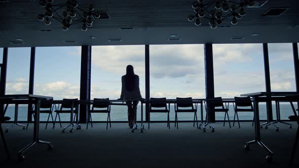 Woman Silhouette Enjoying Break in Conference Room