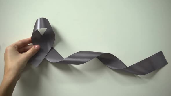 Lady Putting Gray Ribbon on Table, Brain Cancer Awareness Campaign, Treatment