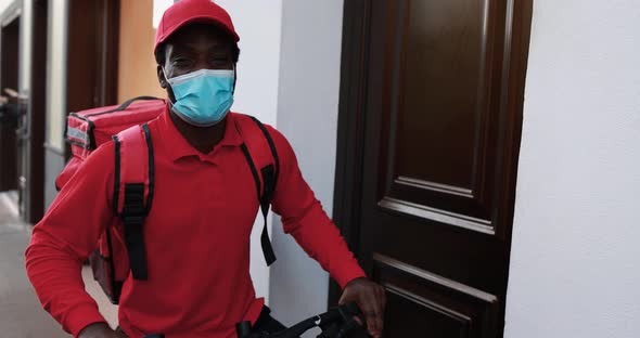 African man delivering meal electric with  bicycle - Courier working for food delivery