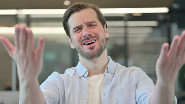 Portrait of Disappointed Man Reacting Loss