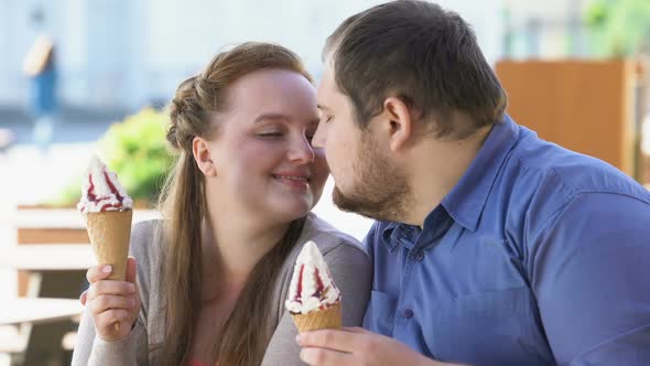 Romantic Couple Nuzzling Holding Sweet Ice-Cream in Hands, Diabetes Risk