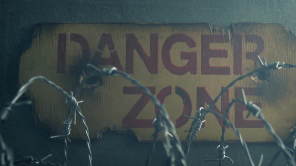Danger Sign With Barbed Wire And Smoke