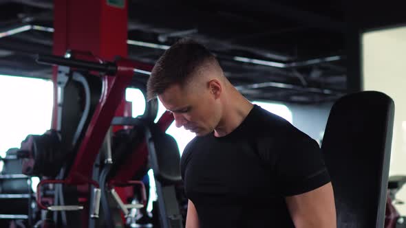 Muscular Man is Engaged in the Gym