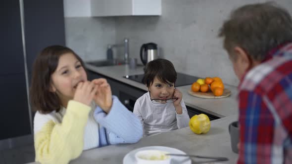 Two Small Children are Together with Grandfather Slow Motion