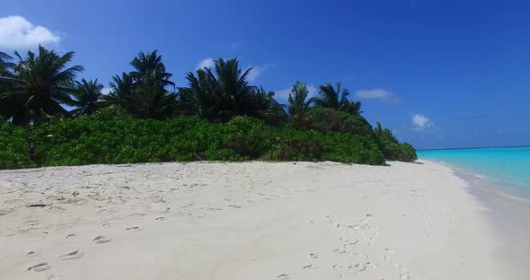 Luxury birds eye island view of a white sand paradise beach and blue ocean background in hi res 4K