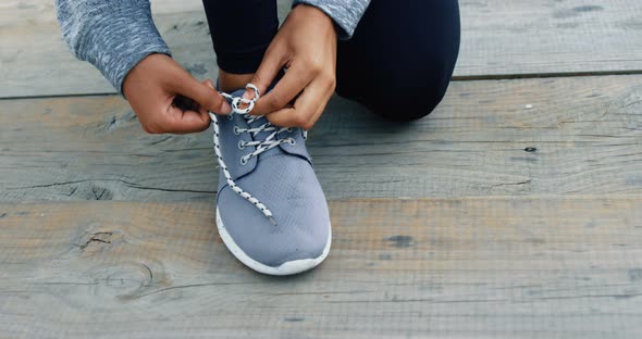 Woman tying her shoes lace 4k