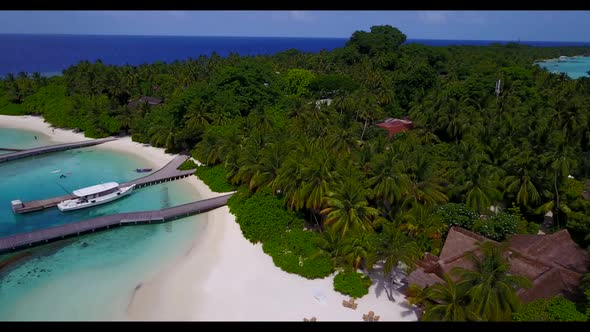 Aerial drone seascape of tranquil coastline beach voyage by turquoise ocean with white sand backgrou