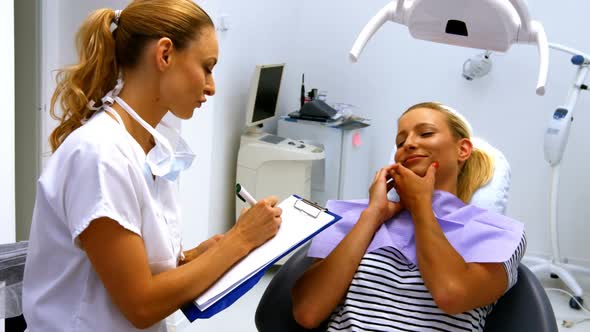 Dentist interacting with female patient