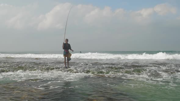 Aged Fisherman Silhouette Stands in Deep Blue Ocean Water