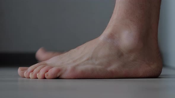 Men's Feet Barefoot on a Floor