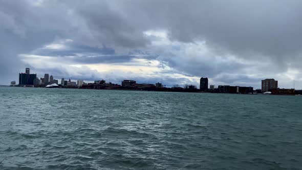 Pan shot of Detroit river waterfront with Detroit skyline in the background seen from belle isle isl