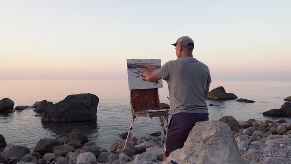 The Artist Man Paints a Seascape Picture