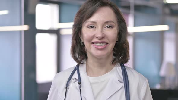 Portrait of Cheerful Middle Aged Professional Doctor Looking at the Camera and Smiling